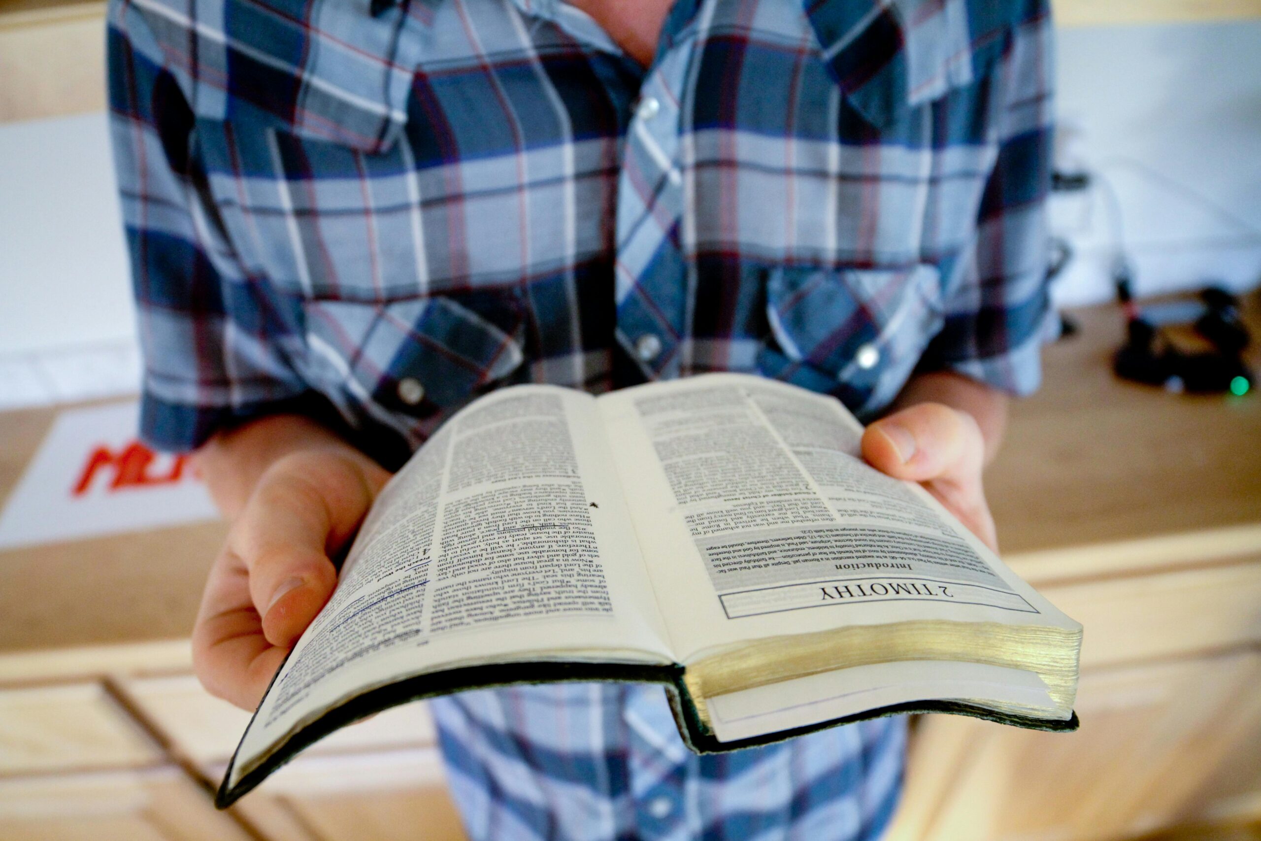 Man holding an open bible — Is Trauma-Informed Care Biblical?
