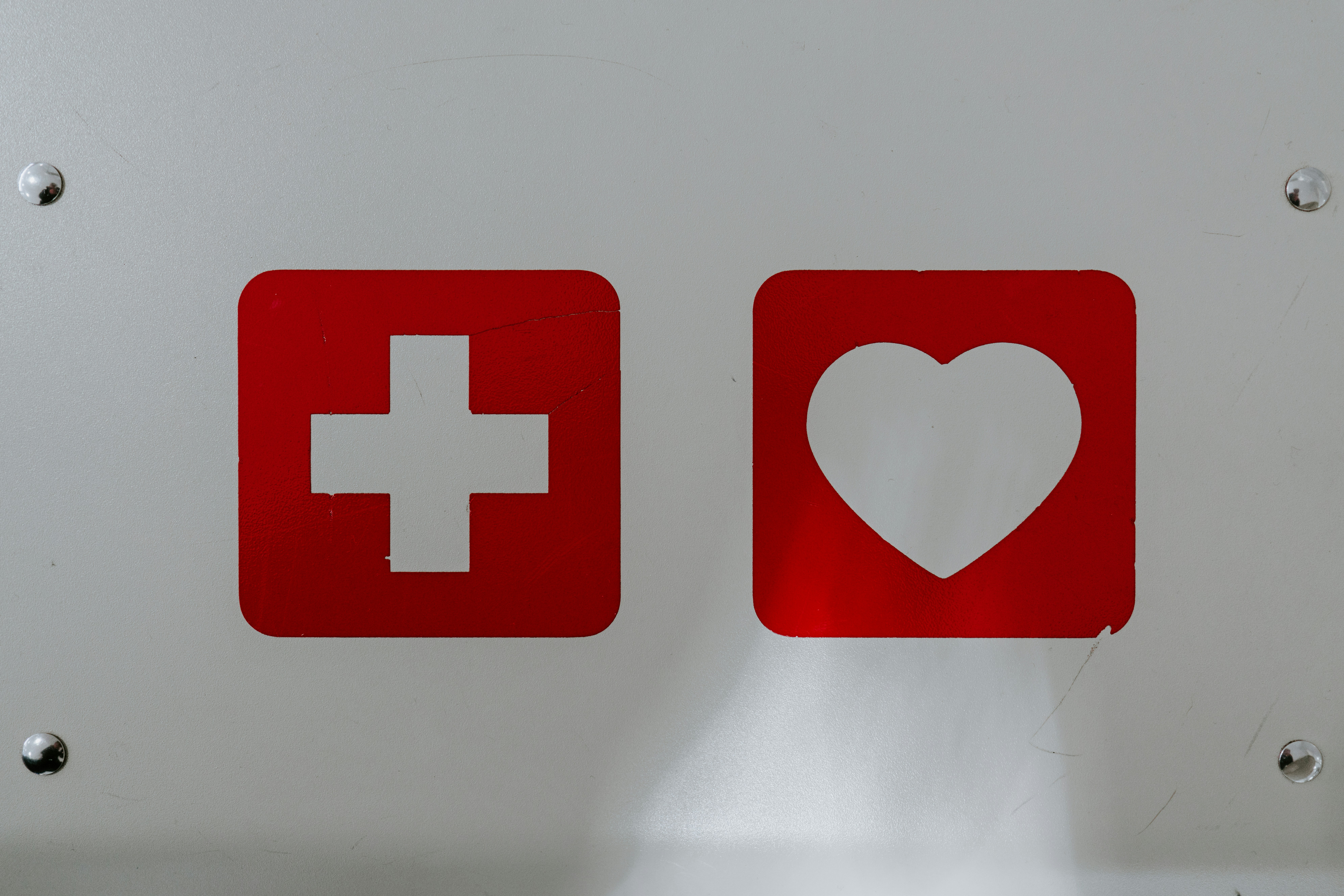 Icons for first aid and a heart symbolize initial trauma care in ministry